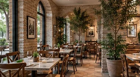 Salão de restaurante com tijolos aparentes e plantas (imagem ilustrativa)